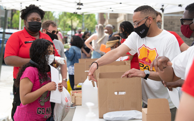 One year after quarantine, the UMB Community Engagement Center brings neighbors back together with its free community lunch program.