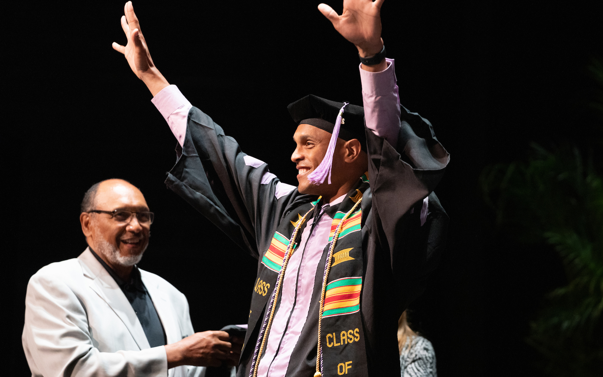 Justin Maxwell DDS '22 is hooded by his father. 