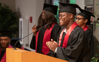 Shakeer Franklin, a Cohort 1 graduate, delivers a student address to the graduating CURE Scholars.