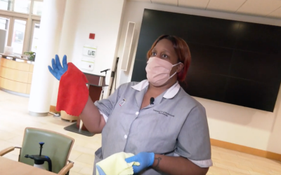 UMB Environmental Services Technician Sierra Tyler explains the color coded microfiber rag system used for campus cleaning. The red cloth in her hand is used for cleaning toilets.