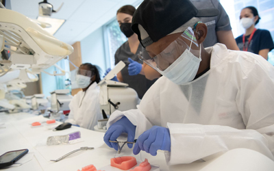 Tavon Carroll practices his oral surgery skills at Planet Smilez Discovering Dentistry Camp. 