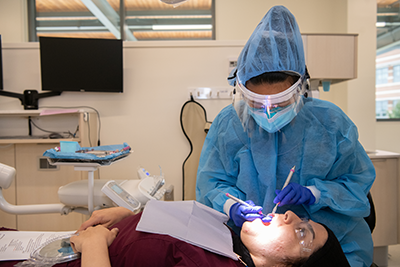 A person cleaning a person's teeth