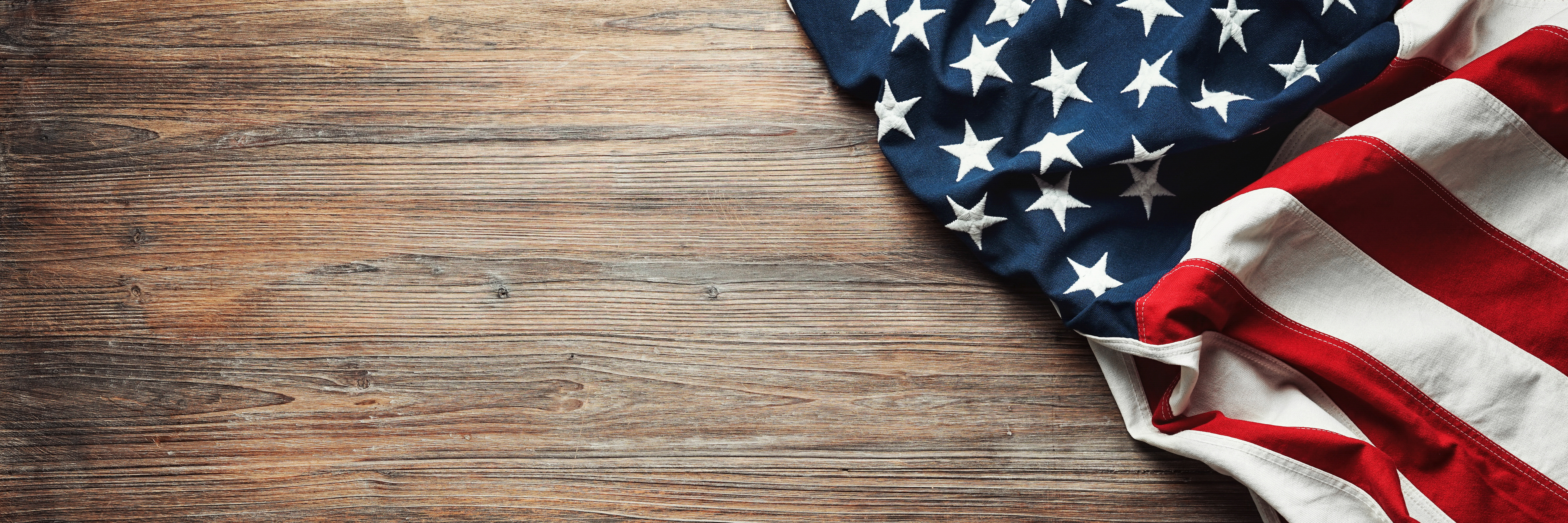 A rumbled American flag on the corner of a wood top