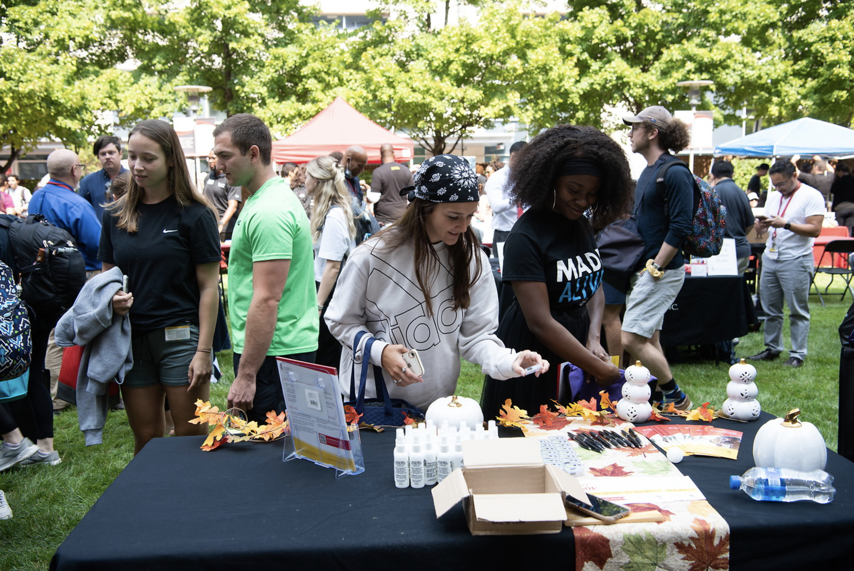 group of students looking at table of items