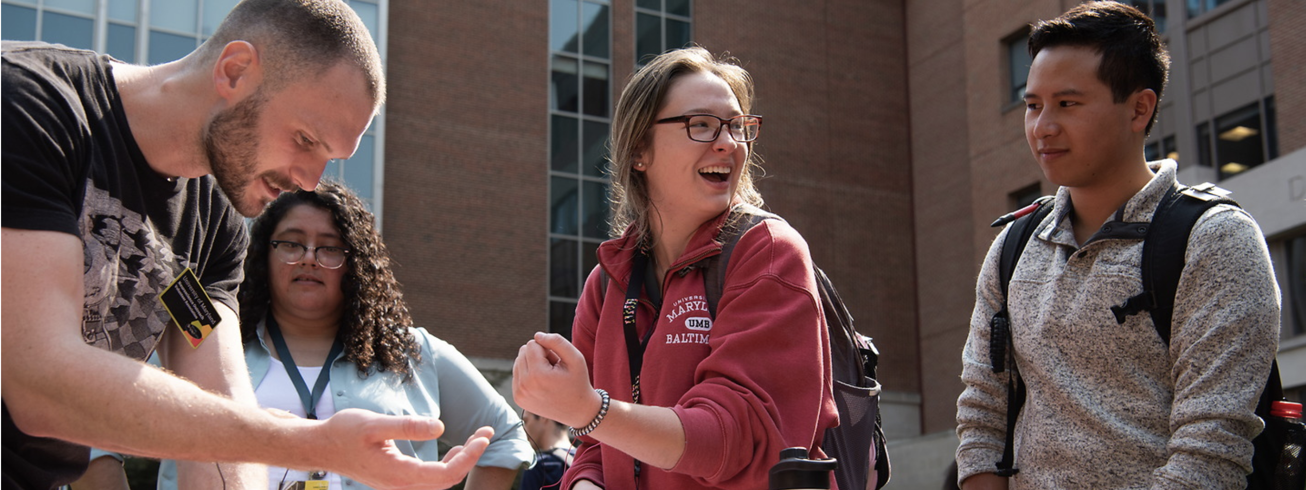 students at involvement fair smiling at table