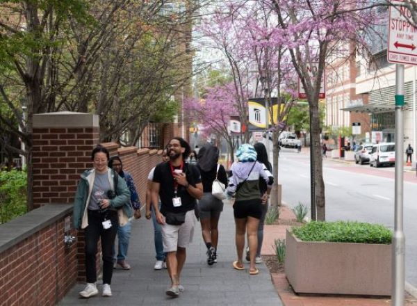 Students walk on UMB sidewalk