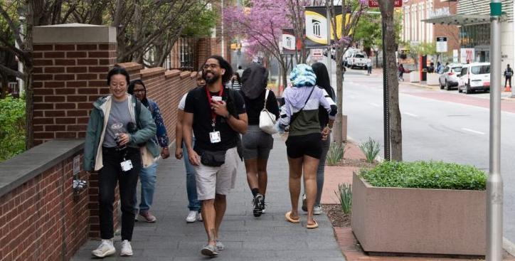 Students walking on sidewalk on UMB campus