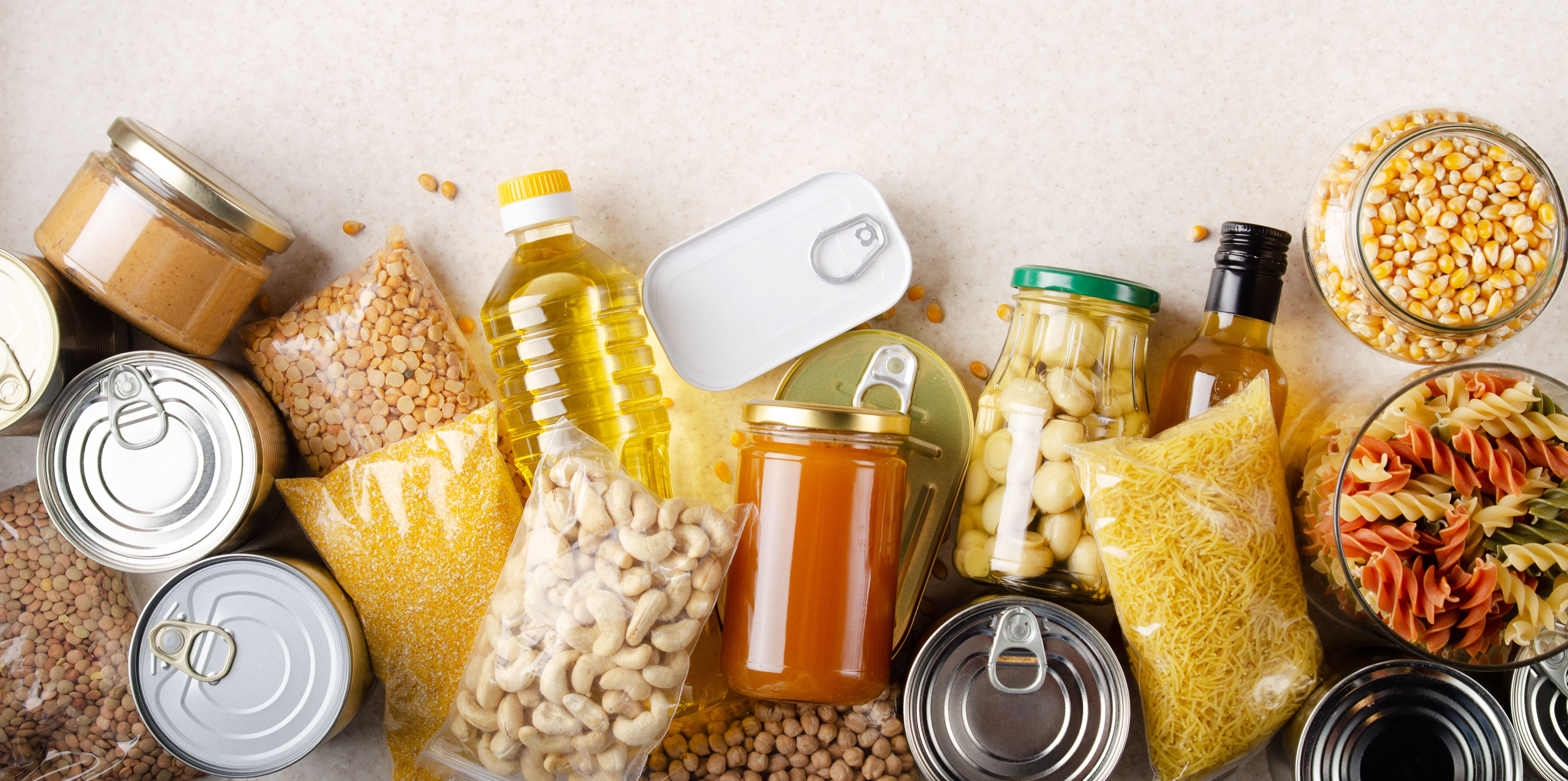 flat lay view at kitchen table full with non-perishable foods