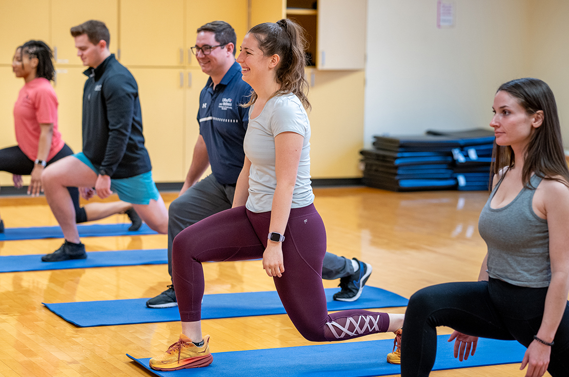 Four students taking an exercise class