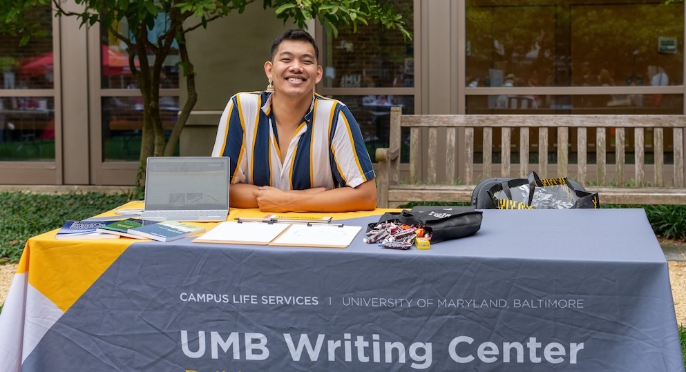 A student at the Writing Center table on campus