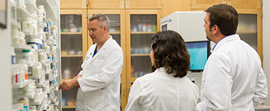 A professor and Students looking at medications