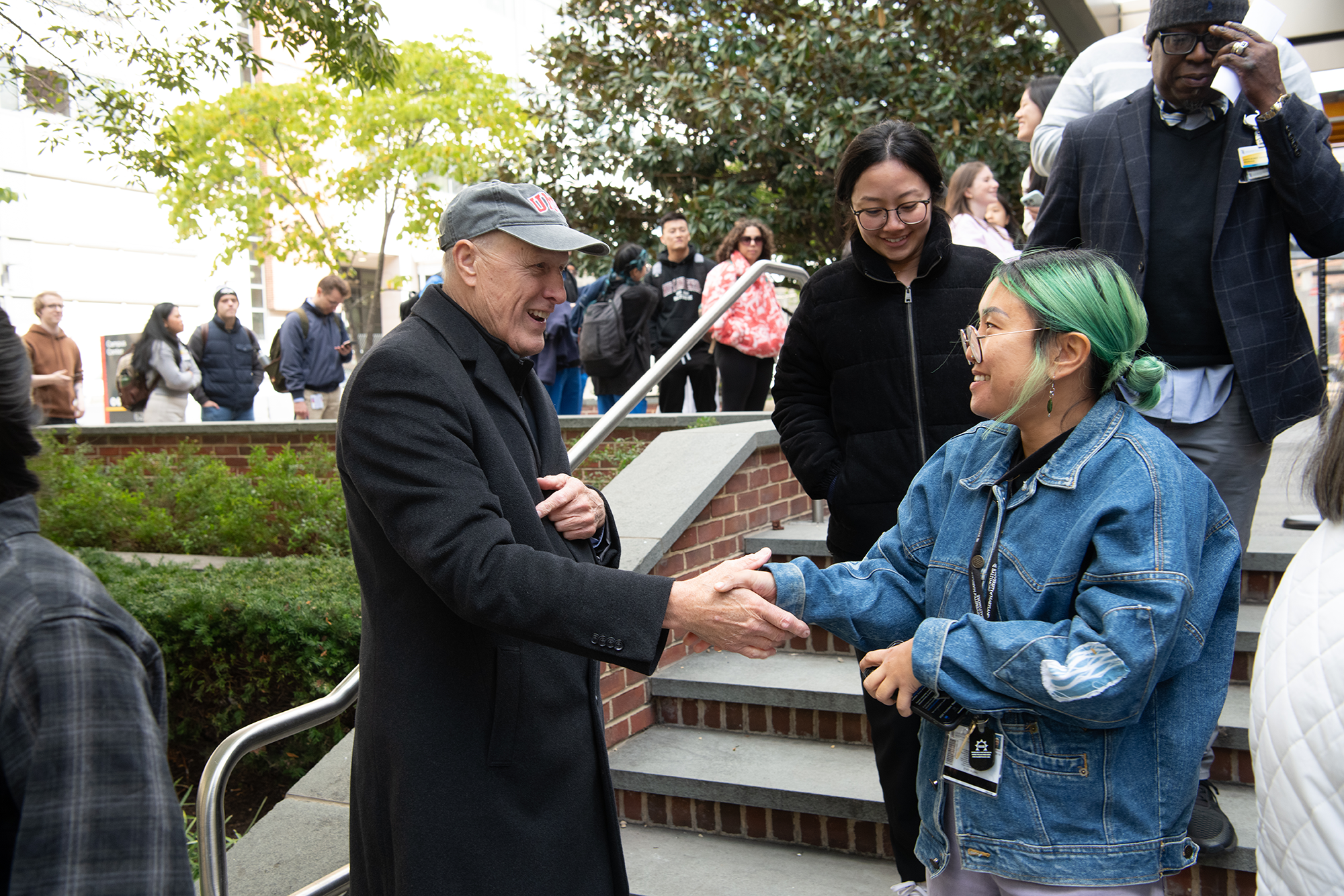 A student shaking the president's hand