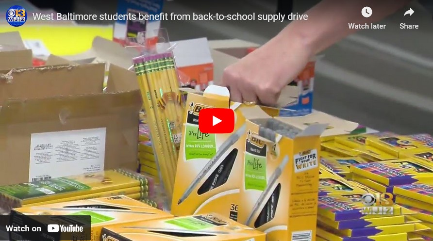 A hand taking out a pen with many boxes of pens around them